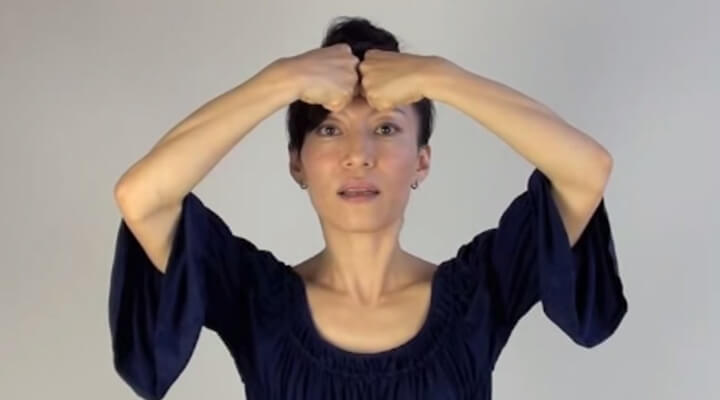 Fumiko Takatsu doing a face yoga exercise for the forehead wrinkles.