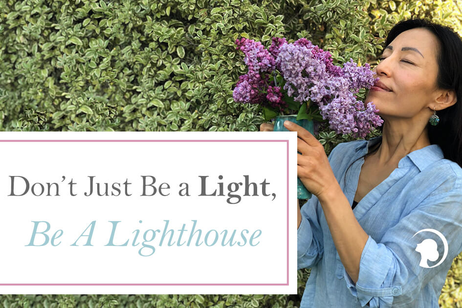 Photo showing Fumiko Takatsu holding and smelling a bouquet of purple flowers. Photo for the blog post cover "Don't just be a light, be a lighthouse".