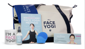A selection of Face Yoga Method products - mug, duffle bag, a book, derma roller, and facial cream. 
