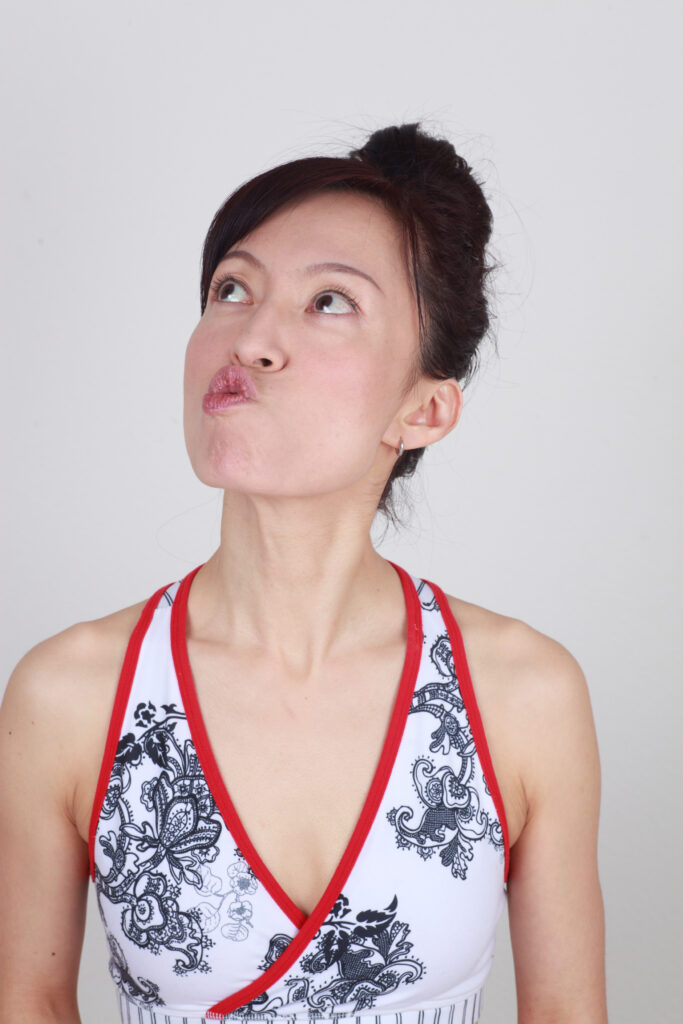 Fumiko Takatsu doing a Face Yoga exercise for reducing neck fat. 