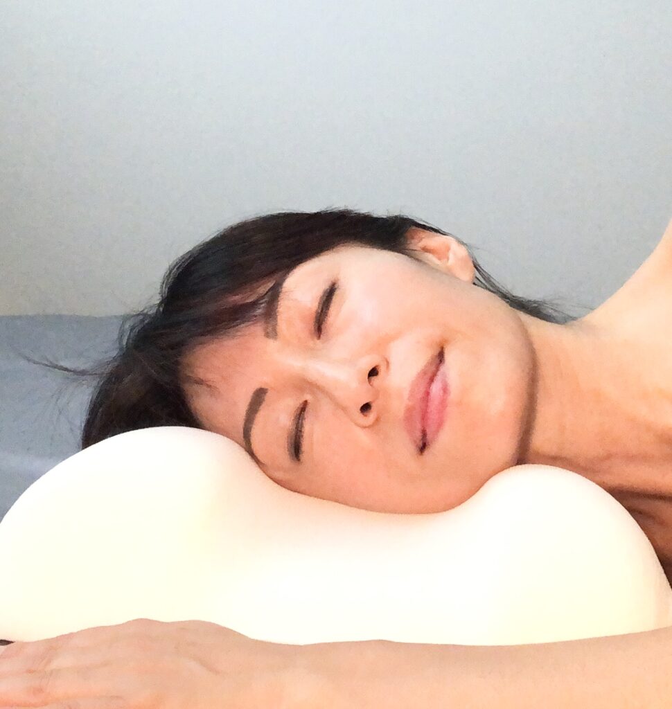 Fumiko Takatsu laying on a pillow.