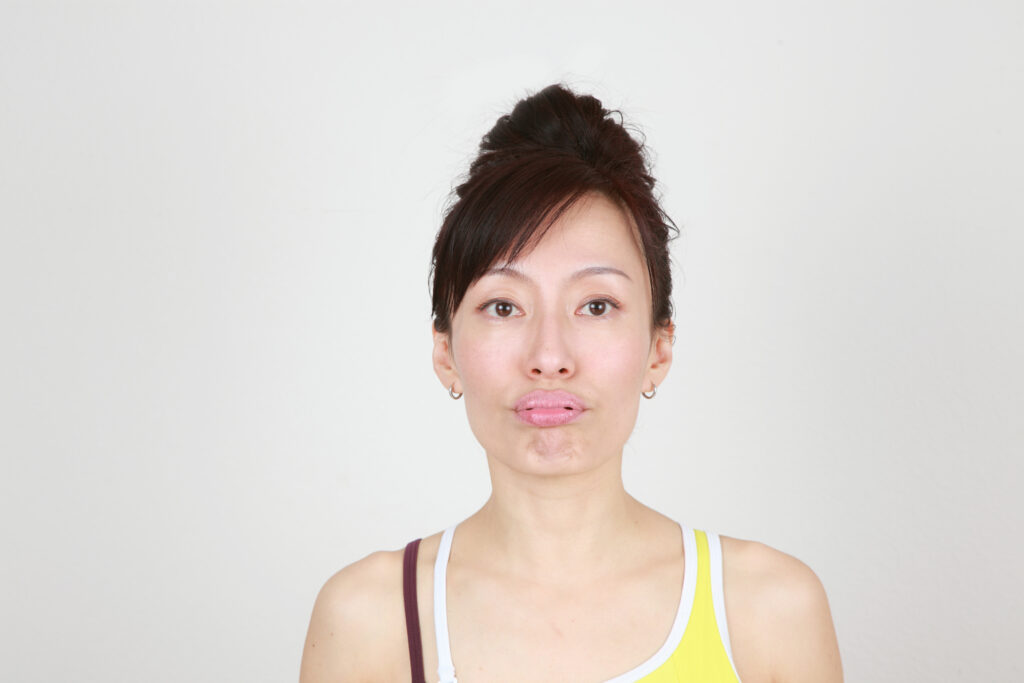 Fumiko Takatsu doing a Face Yoga pose for plump lips. 