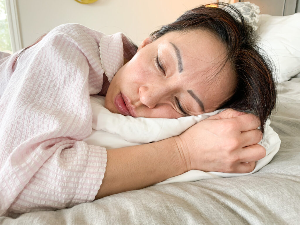 A woman sleeping on a pillow. 