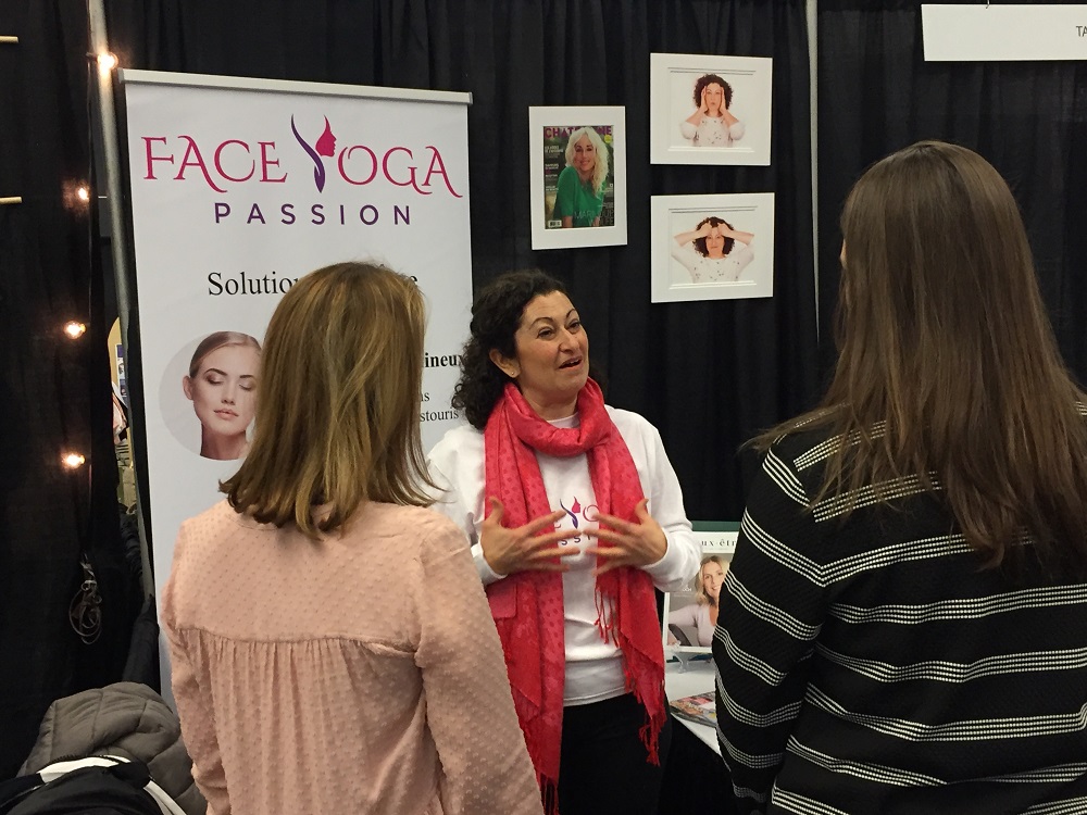Certified Face Yoga teacher and business owner Marie-Reine talking with two clients